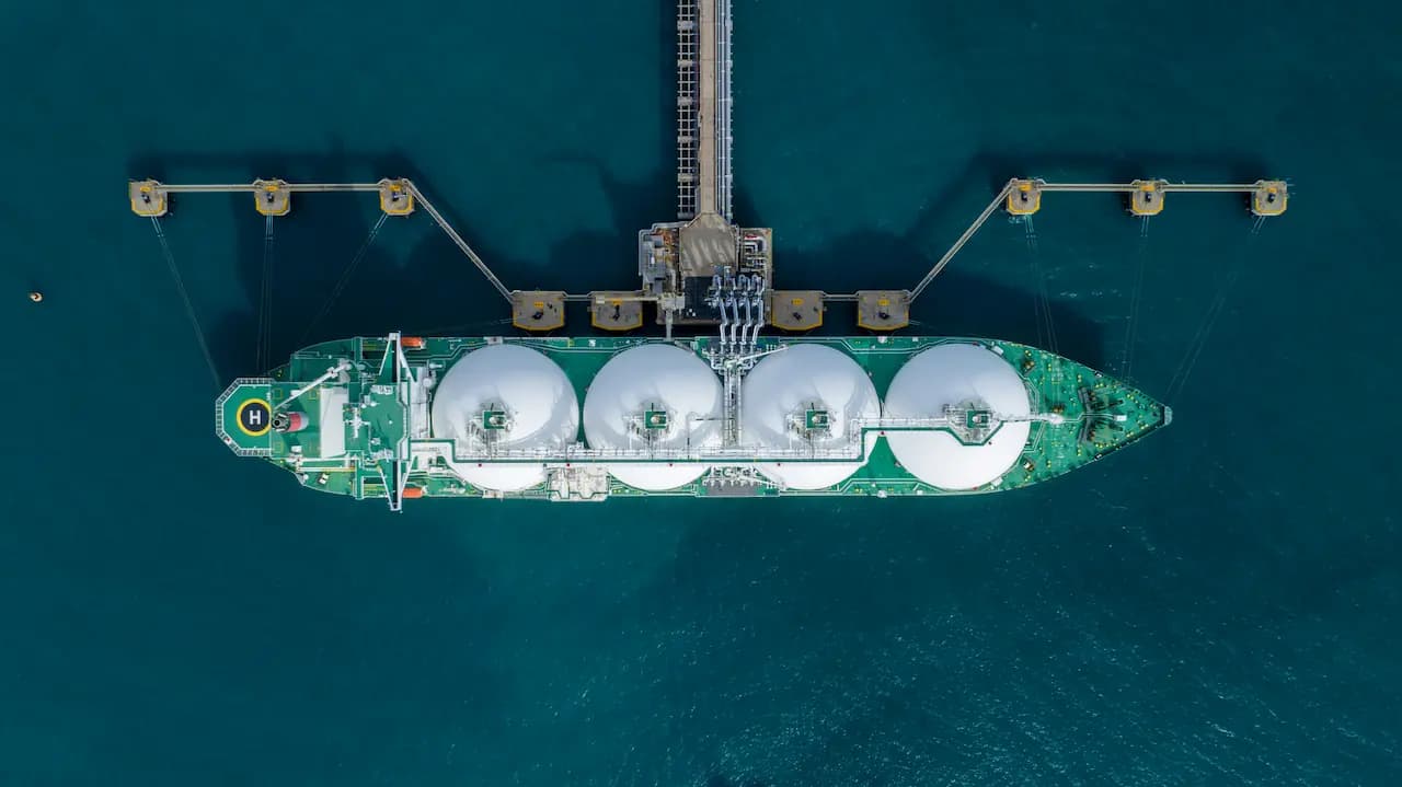 Aerial view of an LNG carrier moored at a marine loading terminal