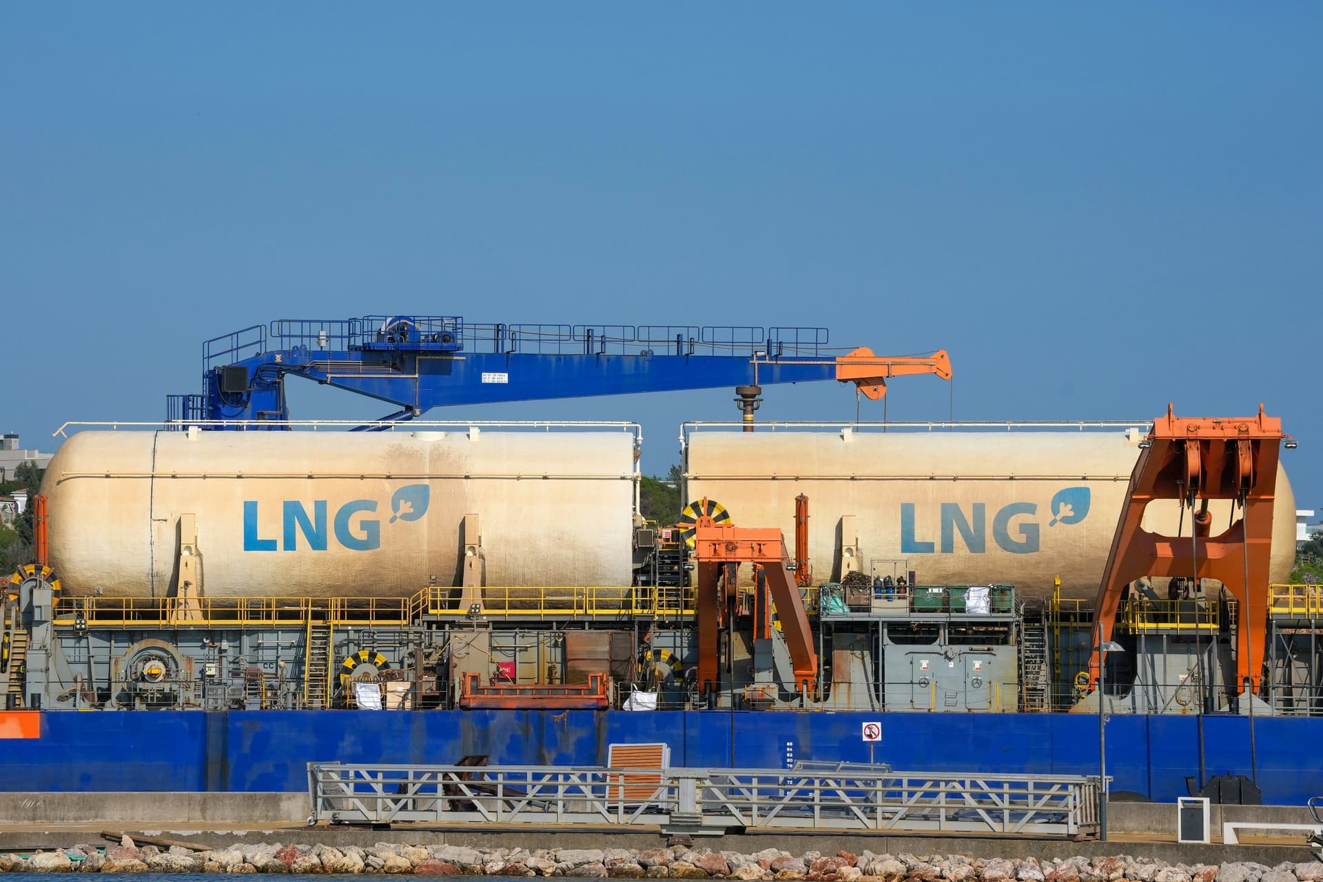 LNG tanks on a terminal vessel under a clear sky