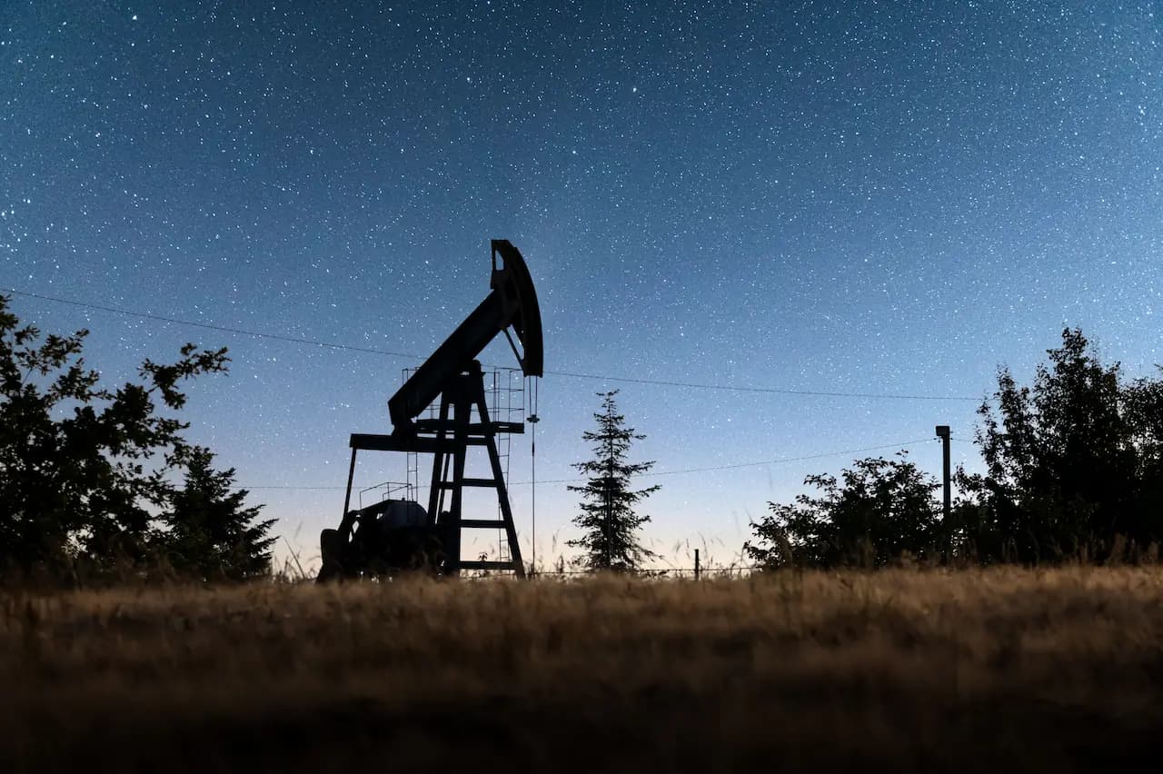 Oil pump jack under a starry night sky